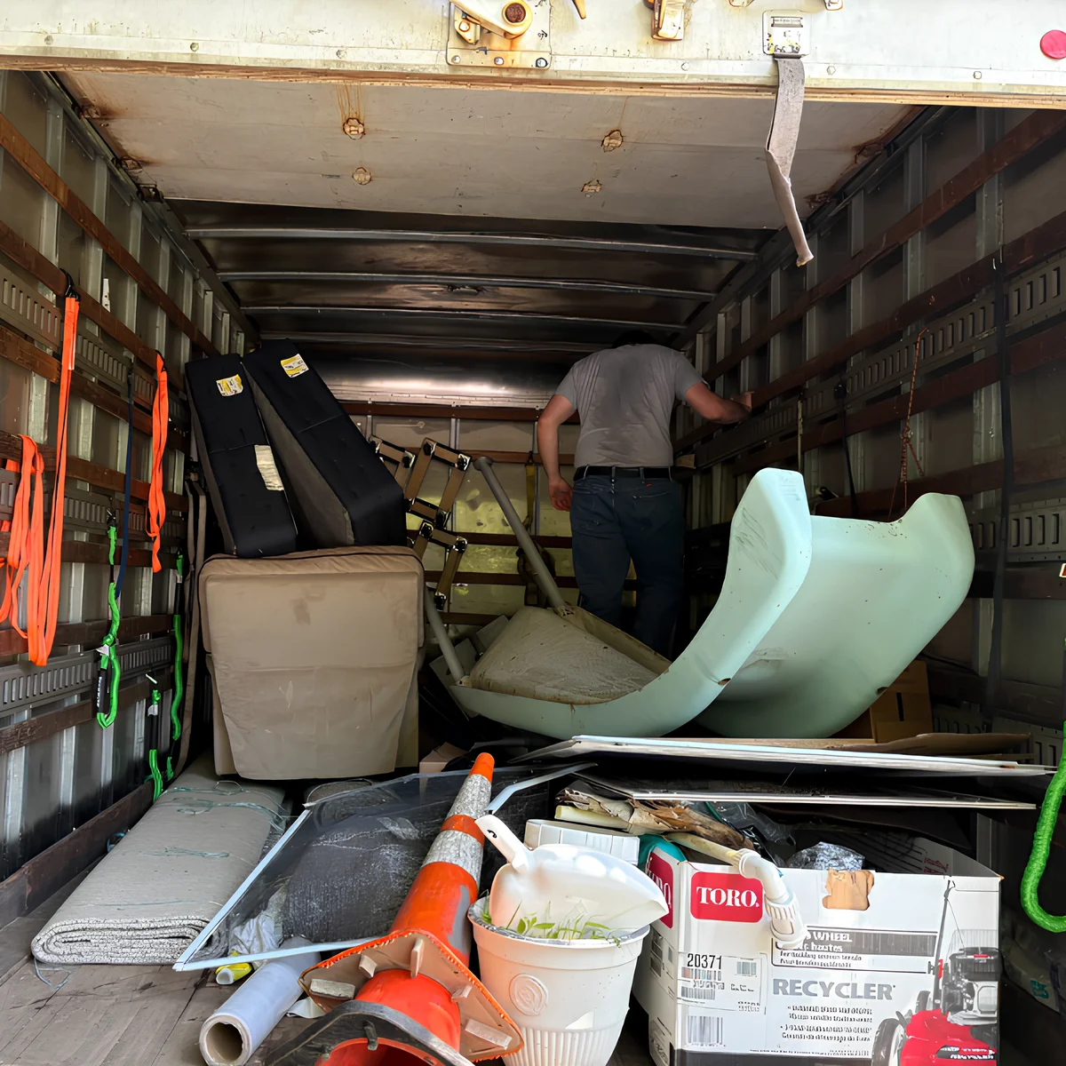 Image showing a junk removal crew member and bulky items in a truck.
